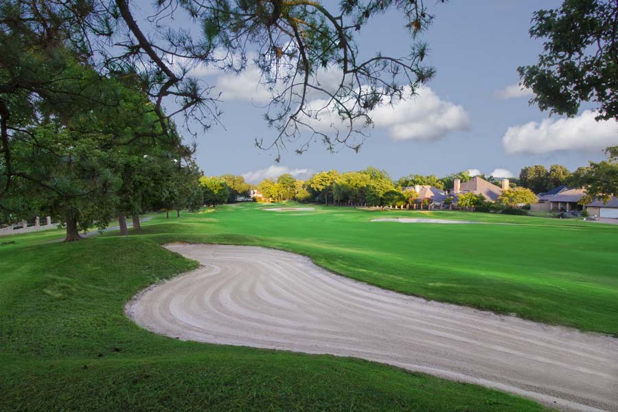 Manicured golf course fairway with bunkers