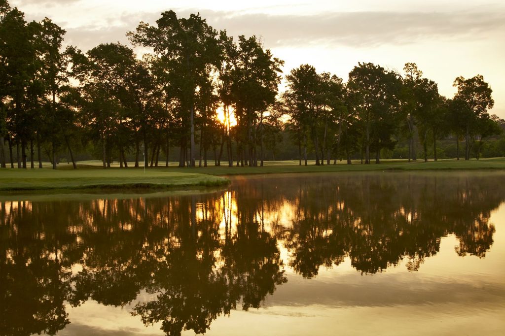 Pond on golf course at sunset
